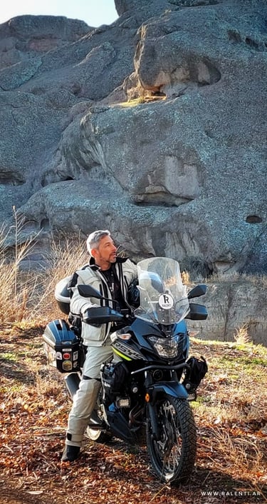 a man sitting on a motorcycle with a motorcycle